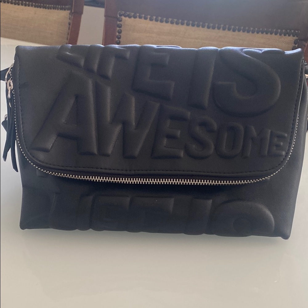 Black Messenger/crossbody Bag Embossed Text and Flap Closure with many pockets